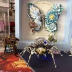 Mechanical spider model in front of steampunk butterfly frame