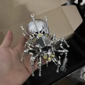 Metallic spider robot model held in hand